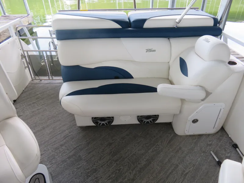 Slide: The Image of Luxurious seating on 2021 JC SportToon 24 TT CS pontoon boat, featuring white and blue upholstery. - 6
