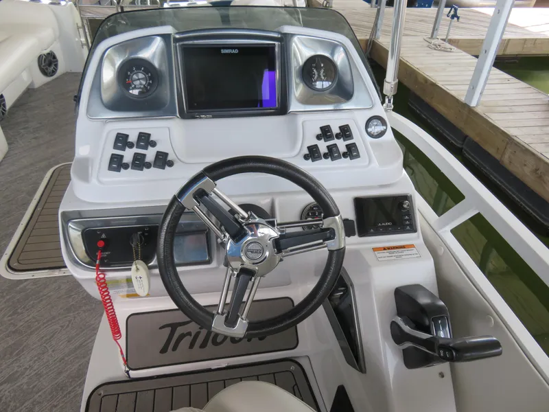 Slide: The Image of 2021 JC SportToon 24 TT CS boat dashboard with steering wheel and control panel. - 7