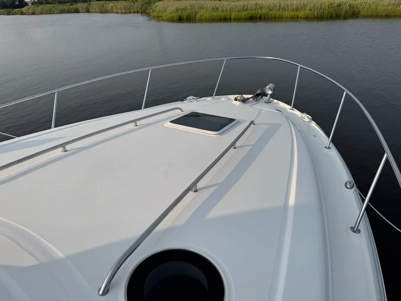 Slide: The Image of Bow view of 2003 Sea Ray 320 Sundancer on calm water. - 11