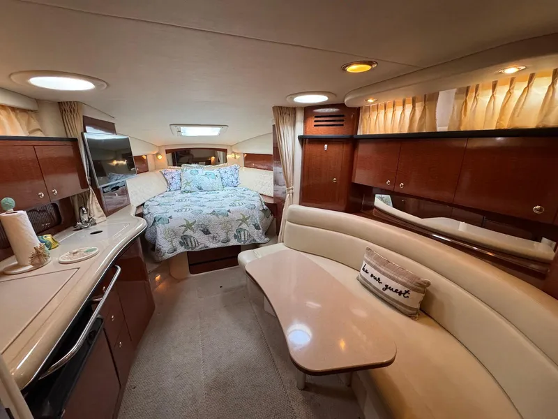 Slide: The Image of Luxurious interior of 2003 Sea Ray 320 Sundancer yacht with cozy bed and seating area. - 12