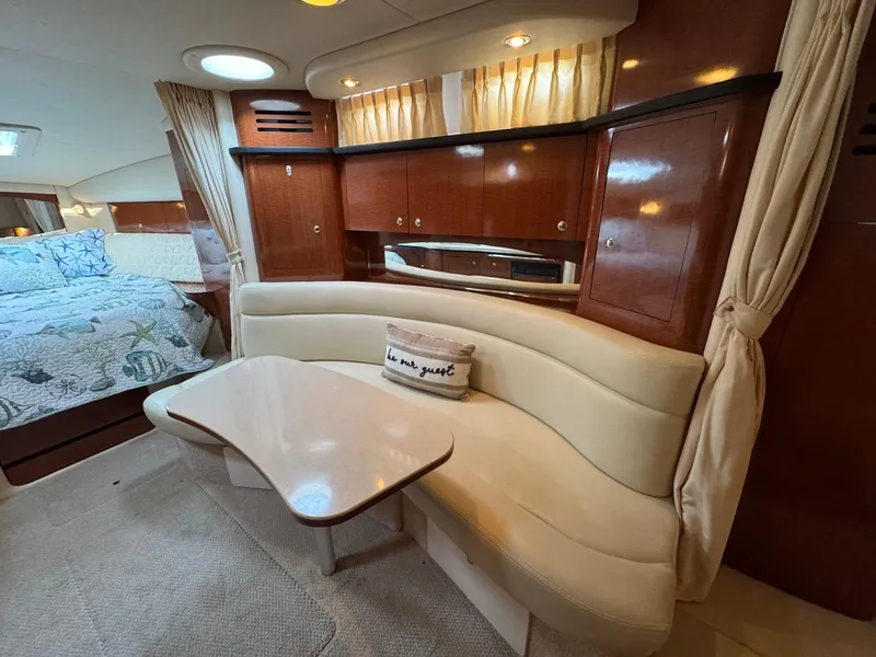Slide: The Image of Luxurious interior of 2003 Sea Ray 320 Sundancer with elegant seating and cozy bedroom. - 13