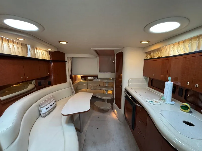 Slide: The Image of Luxurious interior of 2003 Sea Ray 320 Sundancer yacht with elegant seating and kitchenette. - 15