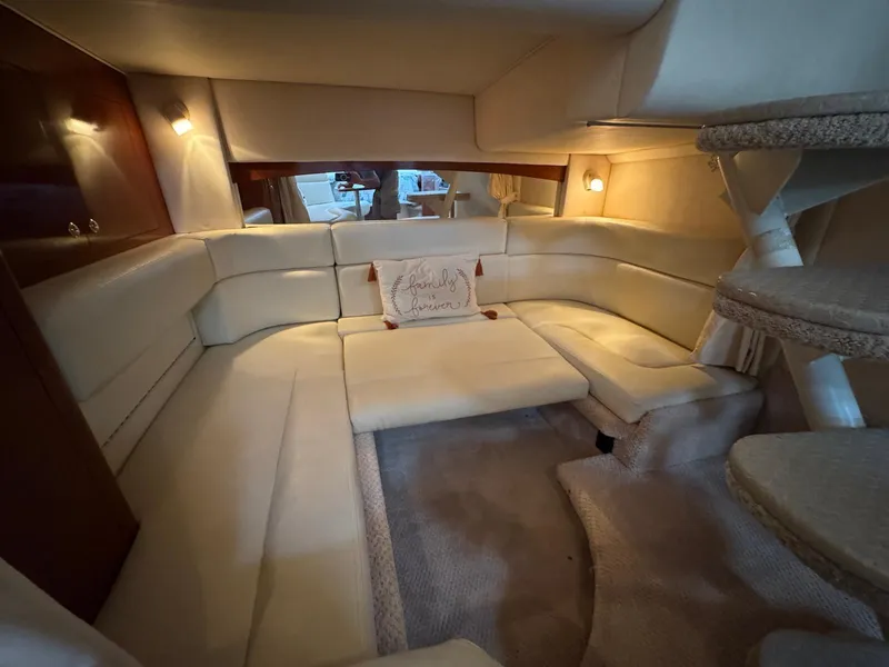 Slide: The Image of Interior of 2003 Sea Ray 320 Sundancer with beige seating and cozy lighting. - 17