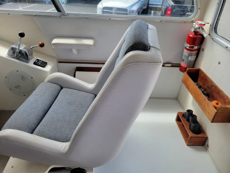 Slide: The Image of Interior of a 1999 SeaSport 2400 XL Limited boat with captain's chair and controls. - 13