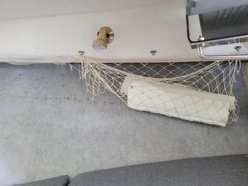 Slide: The Image of Interior of 1999 SeaSport 2400 XL Limited with netted storage and wall-mounted light. - 29