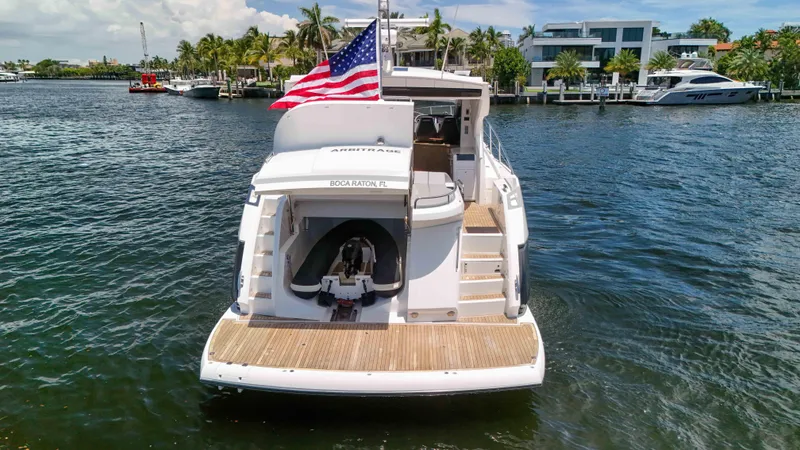 Slide: The Image of Sunseeker Predator 57 yacht, 2017 model, docked in Boca Raton, Florida, with American flag. - 14