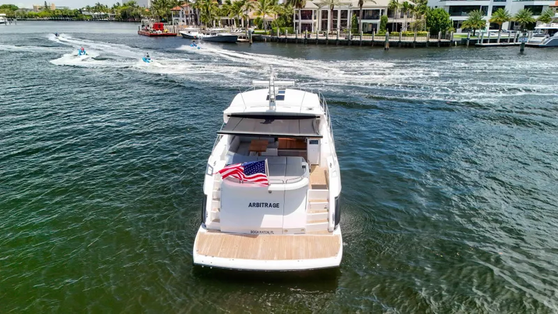 Slide: The Image of 2017 Sunseeker Predator 57 yacht cruising on a scenic waterway with American flag. - 21