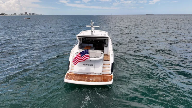 Slide: The Image of 2017 Sunseeker Predator 57 yacht on open water, rear view with American flag. - 27