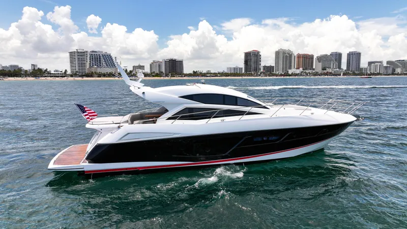 Slide: The Image of 2017 Sunseeker Predator 57 yacht cruising near city skyline on a sunny day. - 30