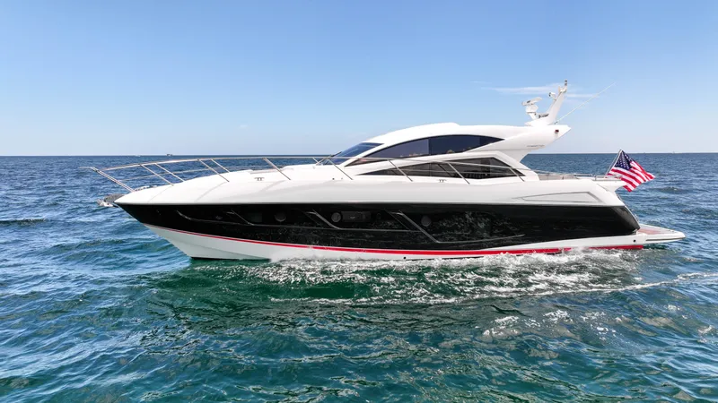 Slide: The Image of 2017 Sunseeker Predator 57 yacht cruising on open sea with American flag. - 35