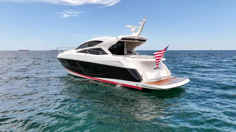 Slide: The Image of 2017 Sunseeker Predator 57 yacht cruising on open sea with American flag. - 36