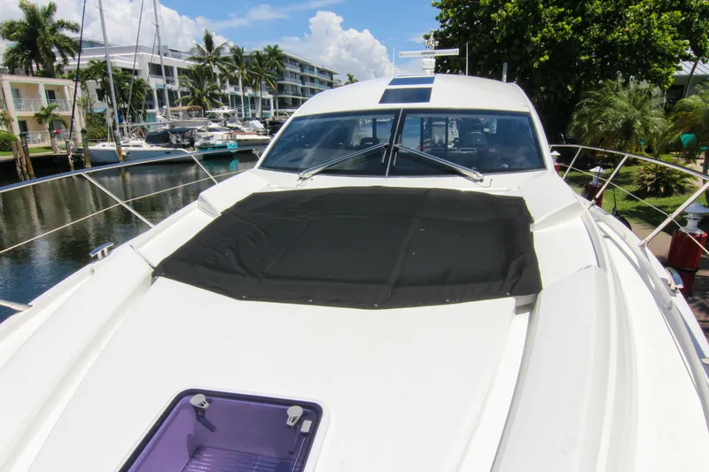 Slide: The Image of 2017 Sunseeker Predator 57 yacht docked near waterfront buildings and palm trees. - 49