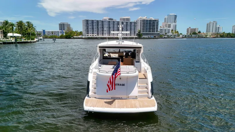 Slide: The Image of 2017 Sunseeker Predator 57 yacht on water, city skyline in background. - 8