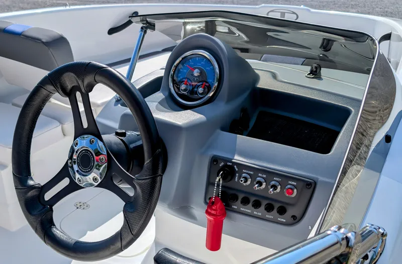 Slide: The Image of 2022 Tahoe T16 boat dashboard with steering wheel and control panel. - 4