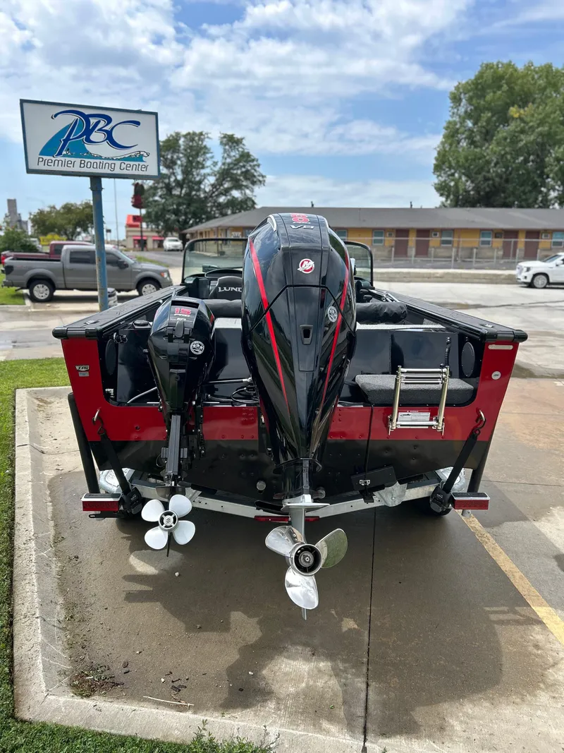 Slide: The Image of 2026 Lund 2075 Fisherman boat at Premier Boating Center, featuring dual outboard motors. - 10