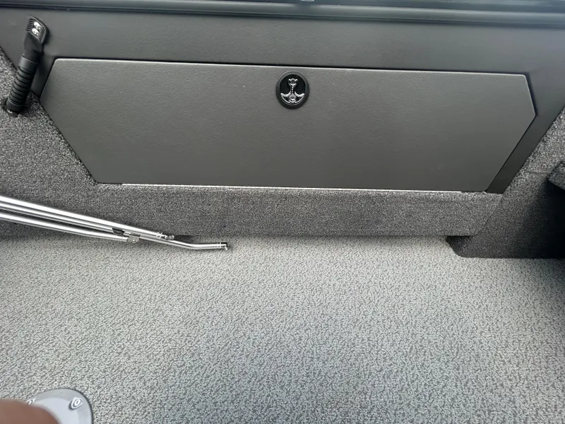 Slide: The Image of Interior of 2026 Lund 2075 Fisherman boat, featuring storage compartment and textured flooring. - 19
