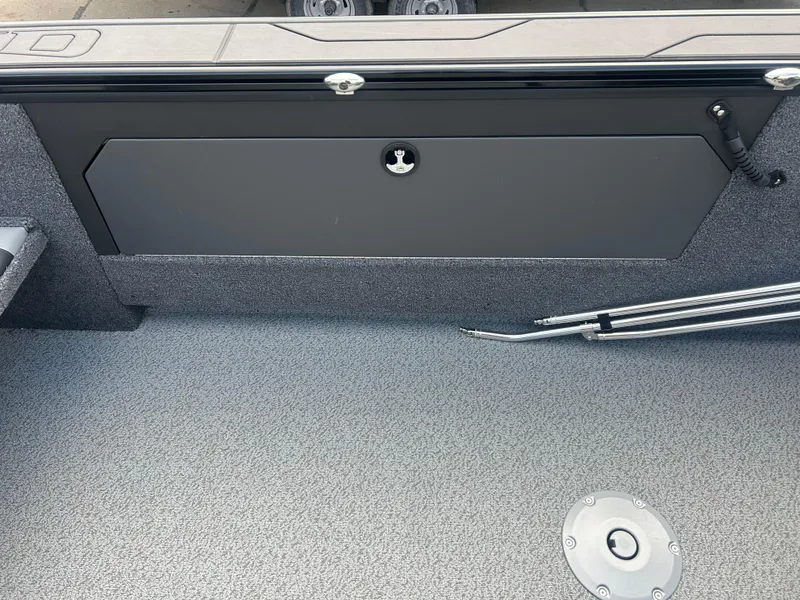 Slide: The Image of Interior view of 2026 Lund 2075 Fisherman boat, featuring storage compartment and floor details. - 20