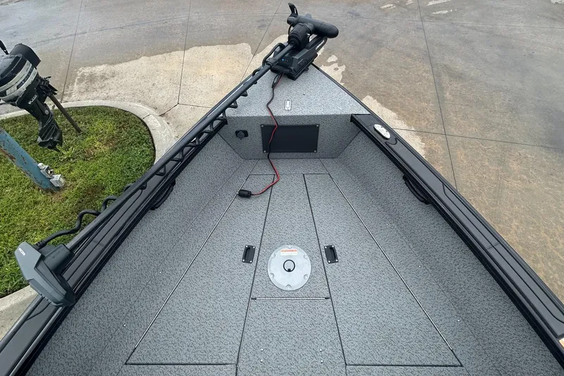 Slide: The Image of 2026 Lund 2075 Fisherman boat interior with trolling motor and storage compartments. - 21