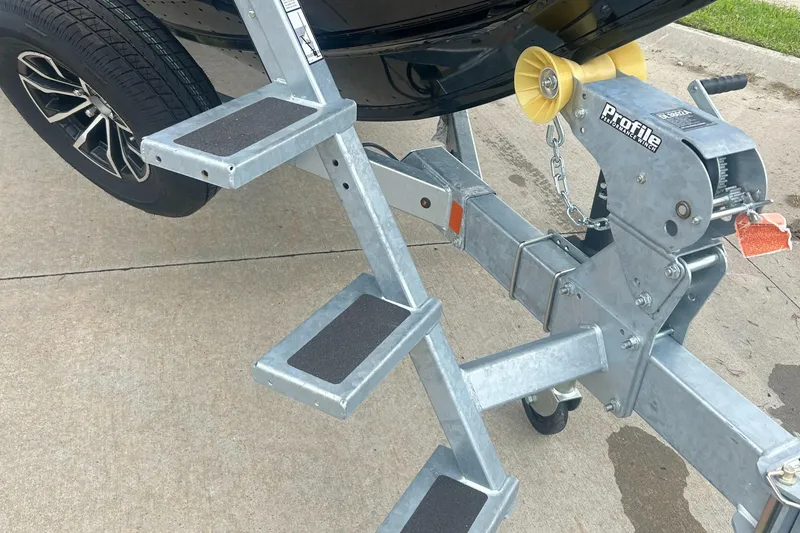 Slide: The Image of Trailer steps and winch on a 2026 Lund 2075 Fisherman boat trailer. - 23