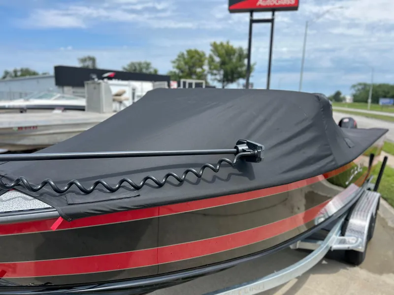 Slide: The Image of 2026 Lund 2075 Fisherman boat with cover on trailer, outdoors. - 5