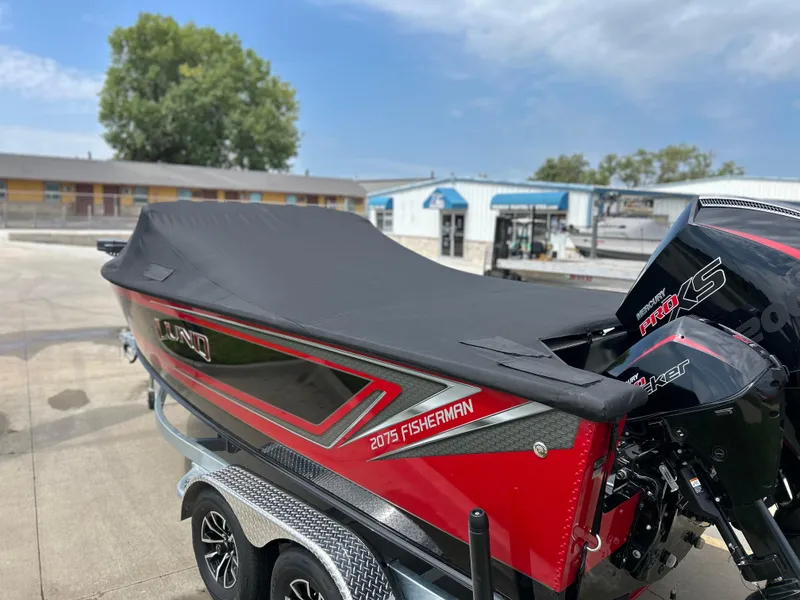 Slide: The Image of 2026 Lund 2075 Fisherman boat with cover, parked on trailer, featuring Mercury Pro XS engine. - 8