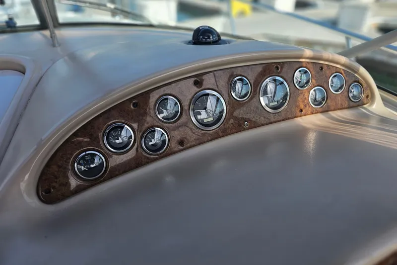 Slide: The Image of Dashboard of 2001 Sea Ray 290 Amberjack boat with multiple gauges and instruments. - 10