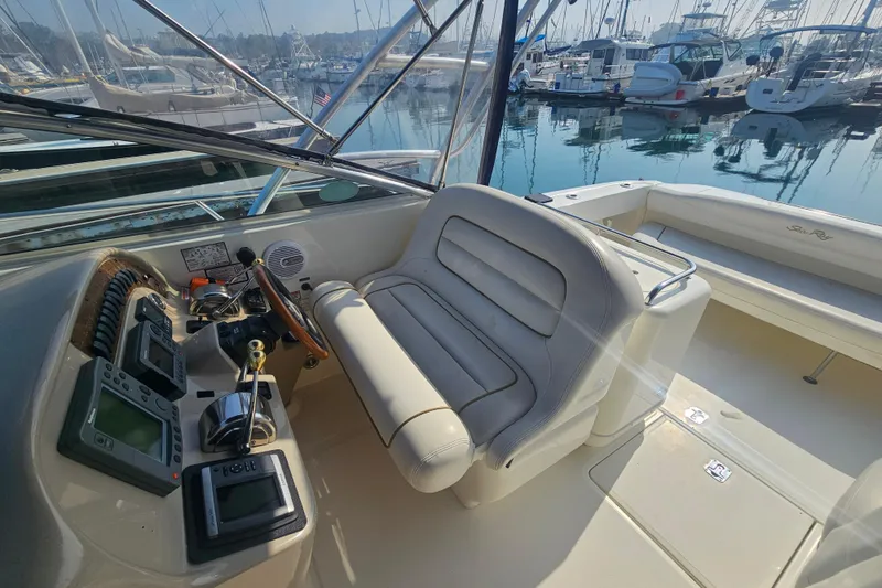 Slide: The Image of 2001 Sea Ray 290 Amberjack cockpit with steering wheel and navigation equipment in marina. - 11