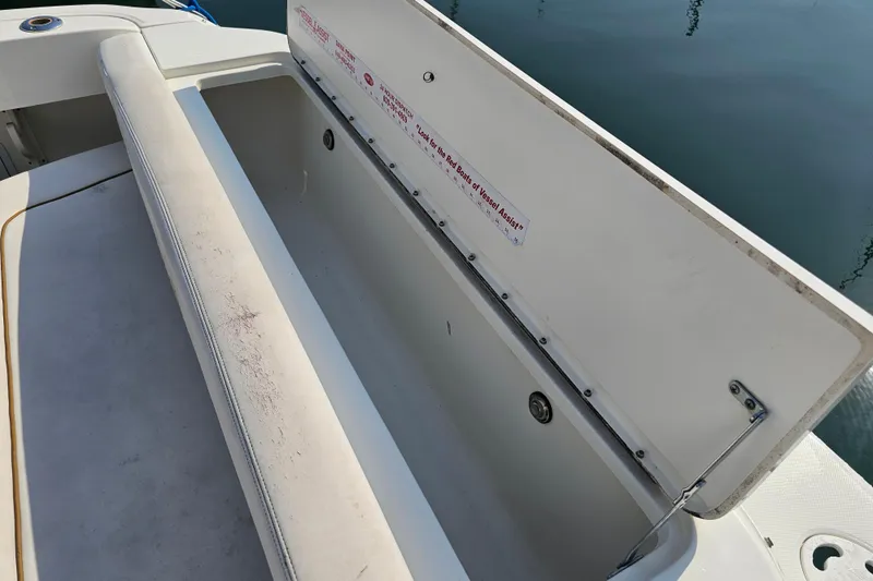 Slide: The Image of Open storage compartment on 2001 Sea Ray 290 Amberjack boat, showing interior details. - 14