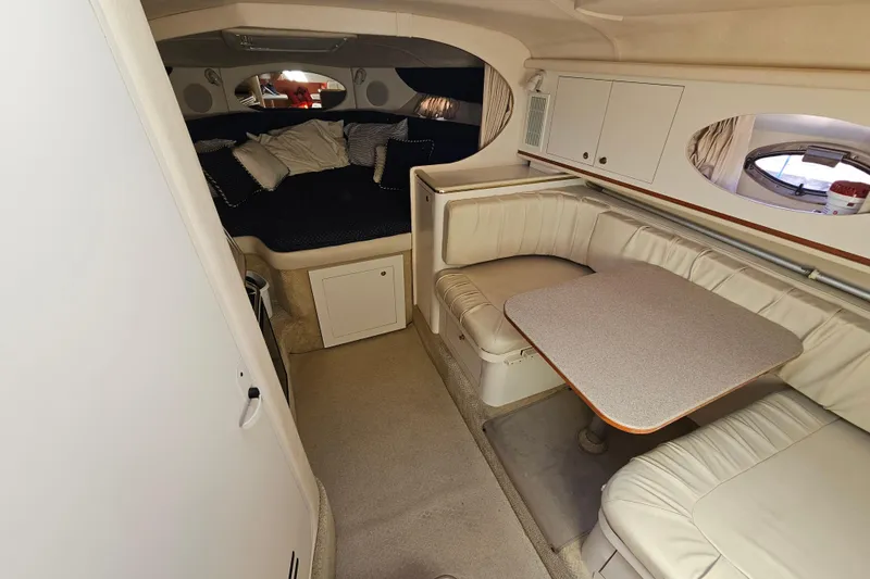 Slide: The Image of Interior of 2001 Sea Ray 290 Amberjack with cozy seating and sleeping area. - 19