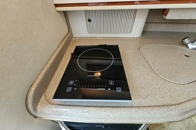 Slide: The Image of 2001 Sea Ray 290 Amberjack kitchen with Insignia induction cooktop. - 21