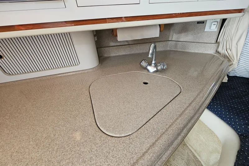 Slide: The Image of 2001 Sea Ray 290 Amberjack boat interior with sleek countertop and faucet. - 22