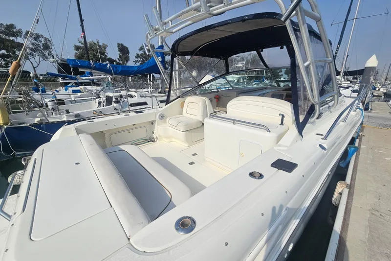 Slide: The Image of 2001 Sea Ray 290 Amberjack boat docked at marina, featuring spacious seating and sleek design. - 4