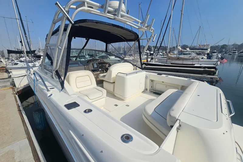 Slide: The Image of 2001 Sea Ray 290 Amberjack boat docked at marina, featuring spacious seating and sleek design. - 5