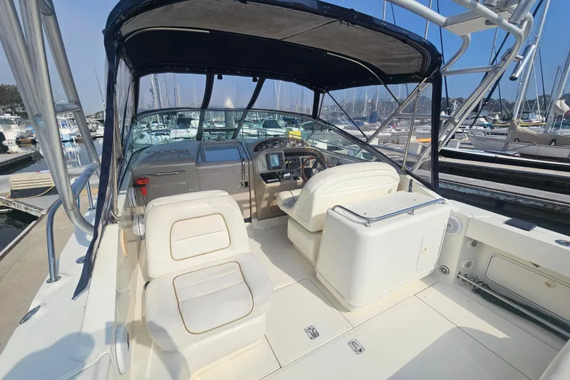 Slide: The Image of 2001 Sea Ray 290 Amberjack boat interior with helm and seating at marina. - 6