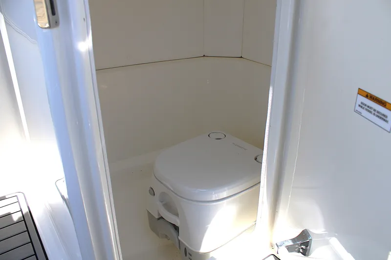 Slide: The Image of 2023 Sea Ray SPX 230 Outboard boat interior with compact marine toilet. - 14
