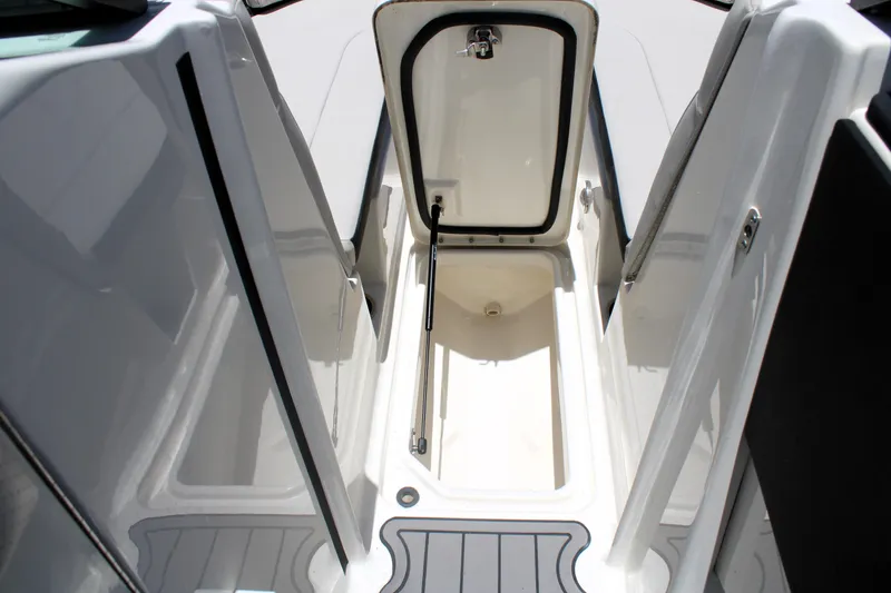 Slide: The Image of 2023 Sea Ray SPX 230 Outboard storage compartment, open hatch, white interior. - 34