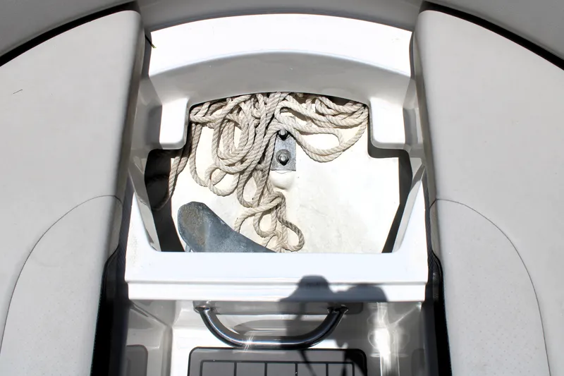 Slide: The Image of 2023 Sea Ray SPX 230 Outboard anchor storage with rope and anchor visible. - 36