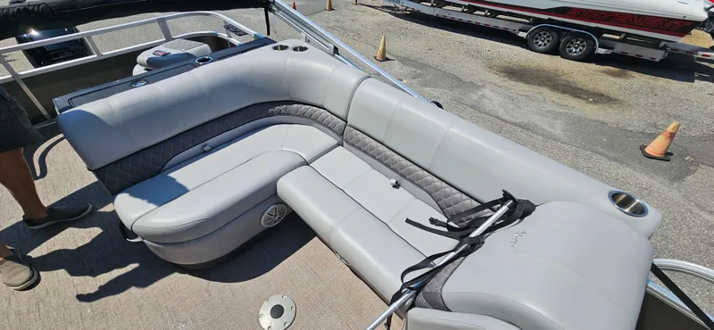 Slide: The Image of Luxurious seating on 2022 Ranger 223FC boat, featuring gray upholstery and cup holders. - 10