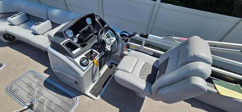 Slide: The Image of 2022 Ranger 223FC boat interior with steering console and seating, featuring modern design and controls. - 14