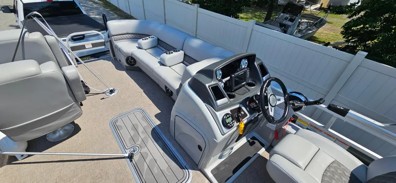 Slide: The Image of Interior of a 2022 Ranger 223FC boat with modern seating and steering console. - 15