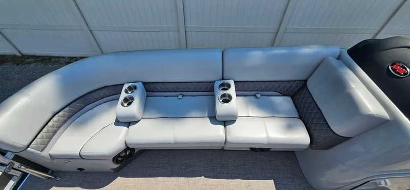 Slide: The Image of 2022 Ranger 223FC boat interior with gray seating and cup holders. - 8