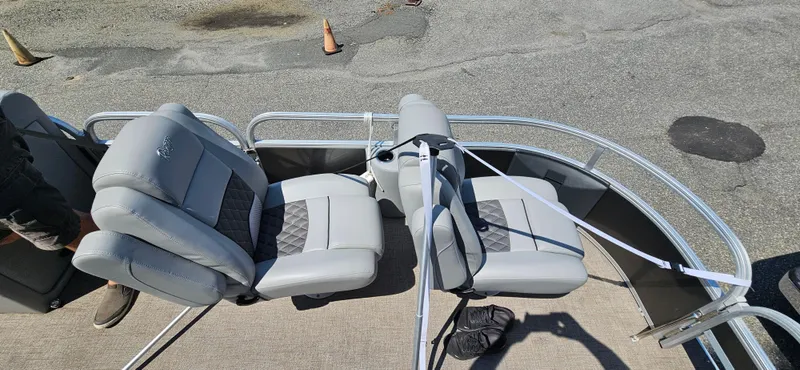 Slide: The Image of 2022 Ranger 223FC boat with gray seating and diamond-patterned upholstery on deck. - 9