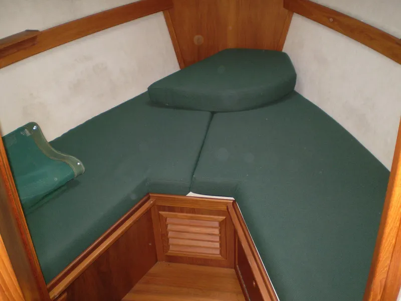 Slide: The Image of 2001 Maple Bay 32' Trawler interior with green cushioned V-berth. - 19