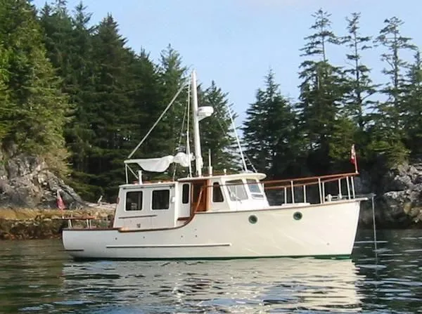 Slide: The Image of 2001 Maple Bay 32' Trawler in scenic forested bay. - 2