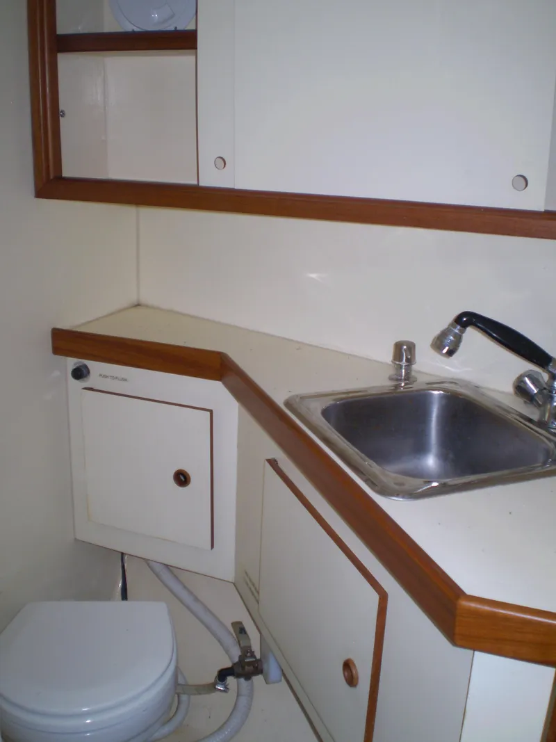Slide: The Image of Compact bathroom in 2001 Maple Bay 32' Trawler with sink and toilet. - 21