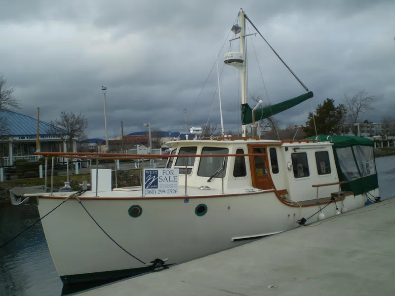 Slide: The Image of 2001 Maple Bay 32' Trawler for sale, docked under cloudy skies. - 4