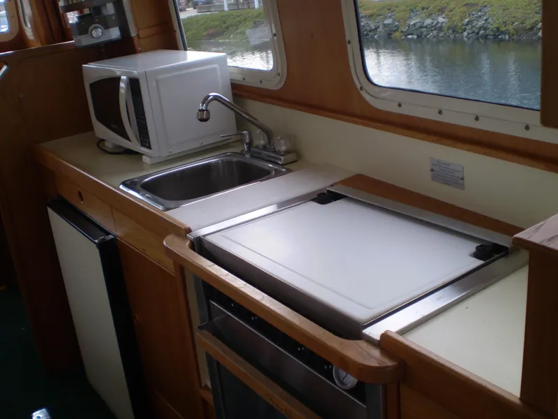 Slide: The Image of Kitchen area of a 2001 Maple Bay 32' Trawler with sink, microwave, and countertop. - 8