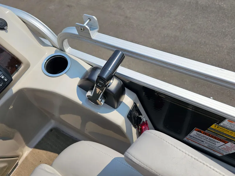 Slide: The Image of Boat control panel of a 2014 Bennington 2275 GL with throttle and cup holder. - 15