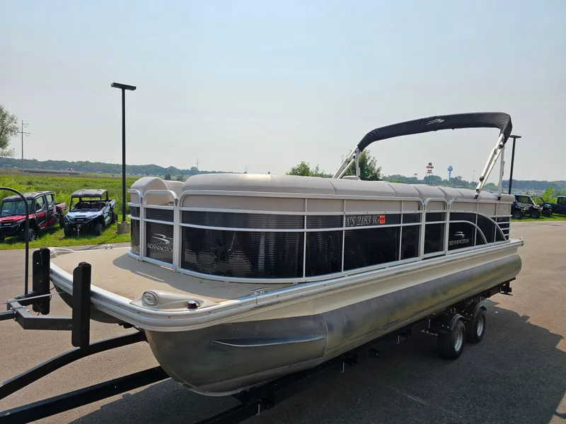 Slide: The Image of 2014 Bennington 2275 GL pontoon boat on trailer, parked outdoors. - 2