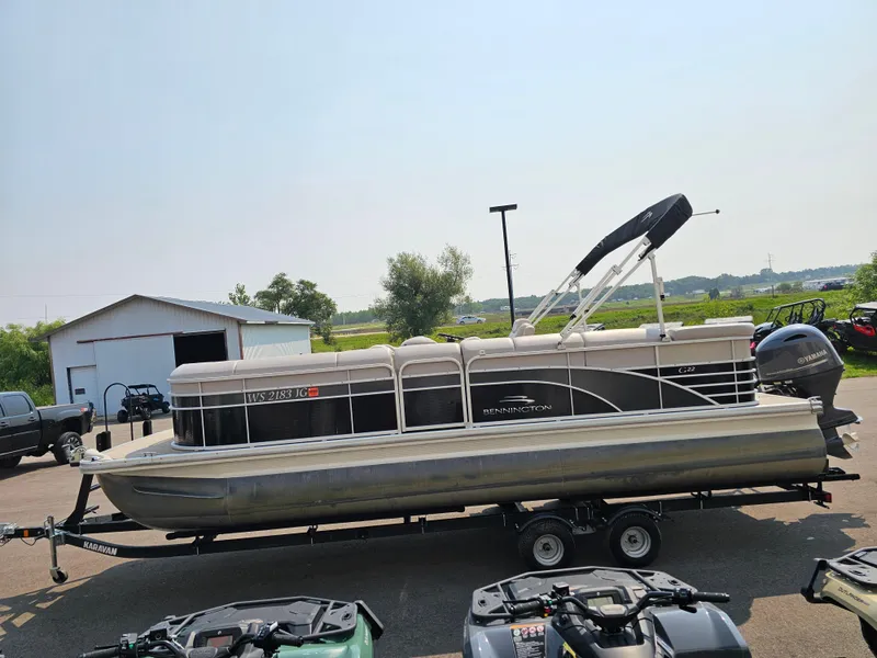 Slide: The Image of 2014 Bennington 2275 GL pontoon boat on trailer, parked outdoors near a shed. - 3